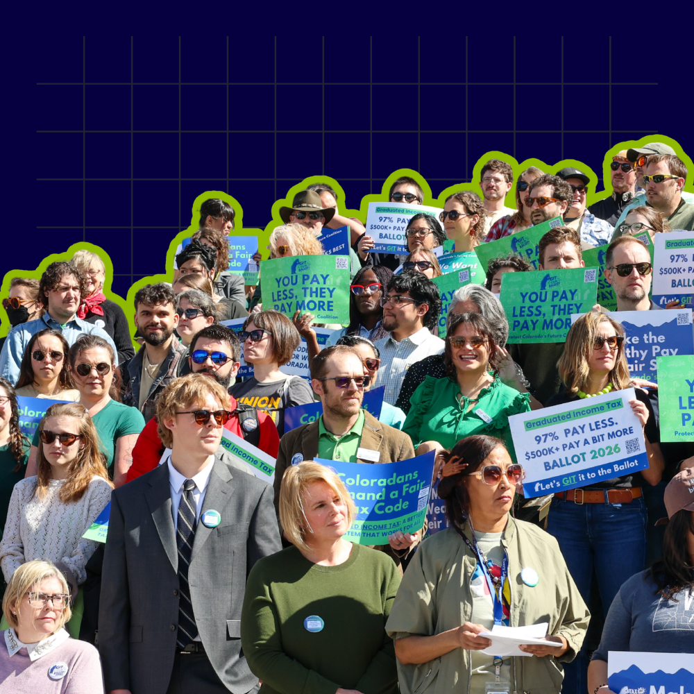 large group of diverse coloradans standing for a press conference with signs reading you pay less, they pay more, 97% pay less. $500K+ pay a bit more